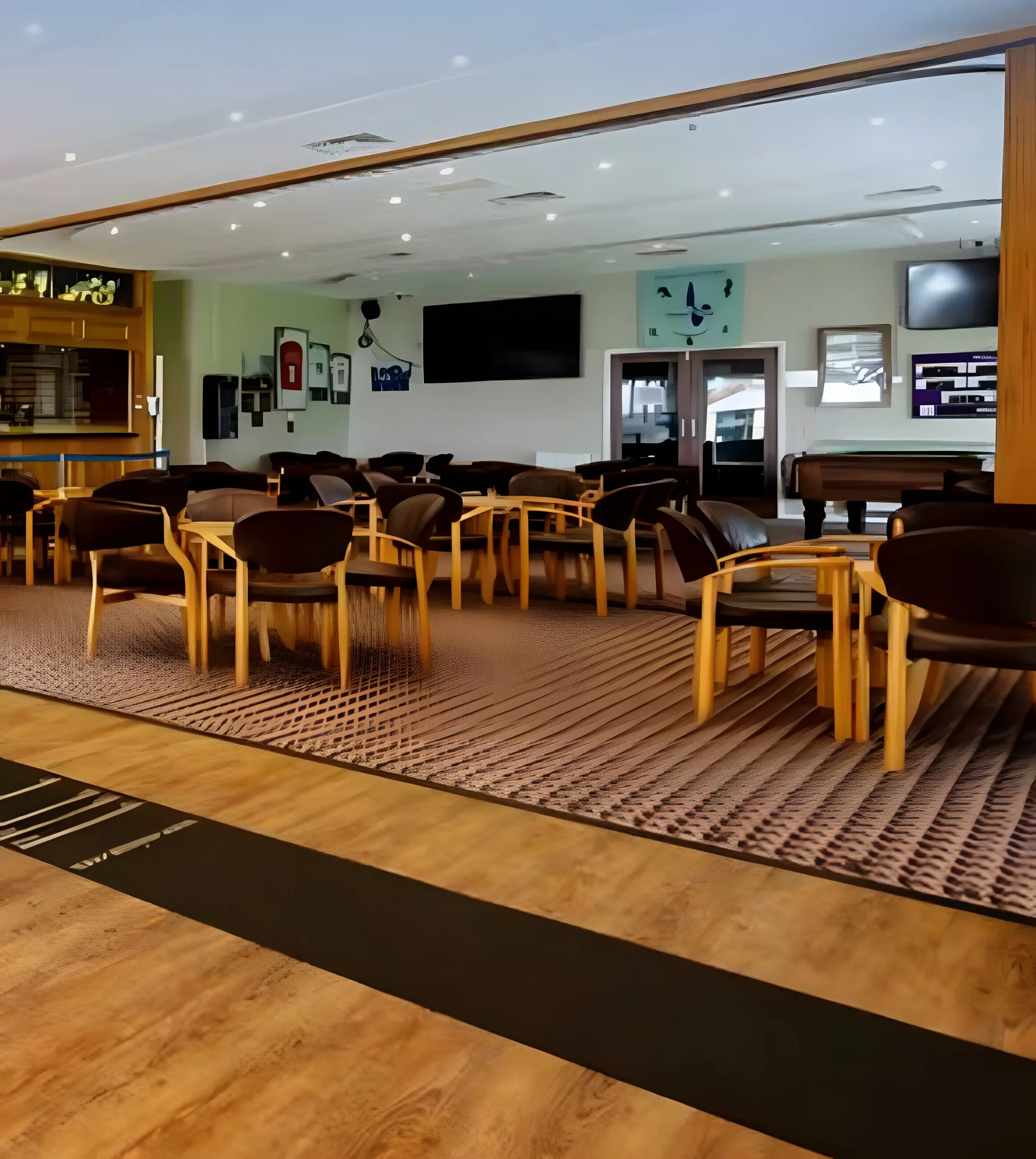 The clubhouse lounge with its bar, tables and televisions