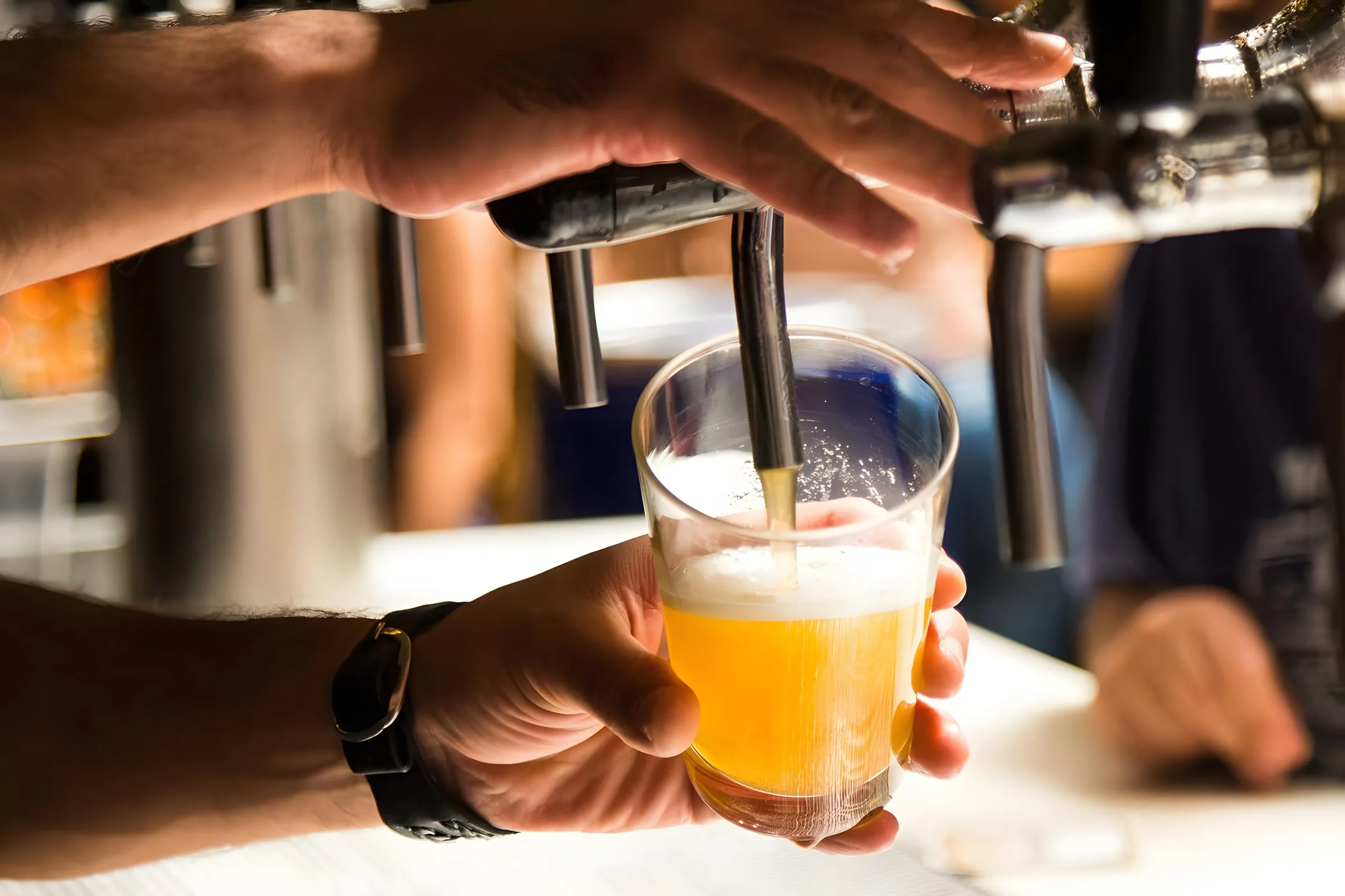 A pint being poured at the bar